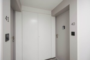 A closed door with a number 41 on the left and a number 40 on the right, both in a hallway with a plain white wall. - Functional Studio Close to the Metro in Warsaw by Noclegi Renters (Warszawa)