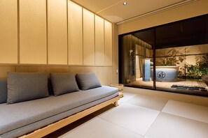 A modern interior with a sofa, a large window, and a view of a traditional Japanese room. - Imakusa-so, Osaka, Tempozan - Tall Lantern - (大阪府大阪市港区築港3丁目)