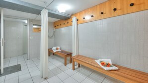 A modern bathroom with a bench, a shower area, and a wooden panel wall. - Emotion Lake Lugano With Direct Lake Access and Shared Pool (Mendrisio)
