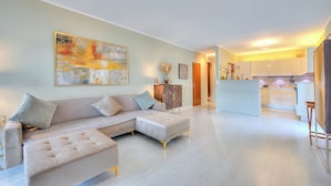 A modern living room with a sectional sofa, a dining area, and a kitchen. - Emotion Lake Lugano With Direct Lake Access and Shared Pool (Mendrisio)