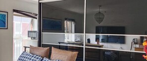 A room with a bed, a desk, a television, and a window with blinds. - The Greenway Retreat - Watford Home: 7BR, Nr London & Studios + Indian Cuisine (Watford)