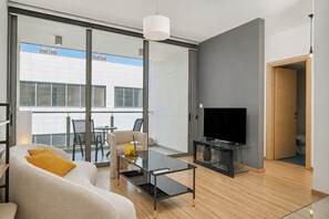A modern living room with a sofa, coffee table, and a flat-screen TV. - Executive Penthouse w/Balcony Central Nicosia (Nicosia)
