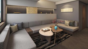 A modern living room with a sectional sofa, a coffee table, and decorative items.