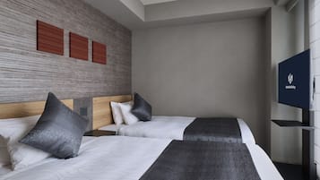 A hotel room with two beds, a flat-screen TV, and a textured wall.