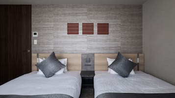 A hotel room with two beds, a wooden headboard, and a control panel on the wall.