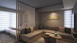 A modern living room with a sectional sofa, a coffee table, and a decorative vase.