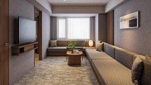 A modern living room with a flat-screen TV, a sofa set, a coffee table, and a large window with curtains.
