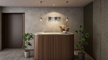 A reception area with a wooden reception desk, two potted plants, and a wall-mounted sign that reads 'Good Monday.'
