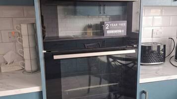 A kitchen with a built-in oven and a 2-year free offer sign.