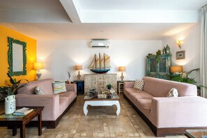 A living room with two sofas, a coffee table, and decorative items. - Staymaster Divli - 3BR Villa in Candolim (Candolim)