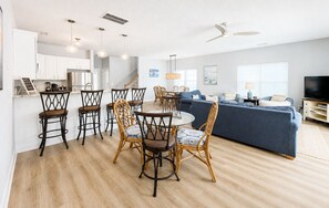 A modern living space with a dining area, kitchen, and seating area. - Lady Luck - Second Row in Surfside Beach (Surfside Beach)