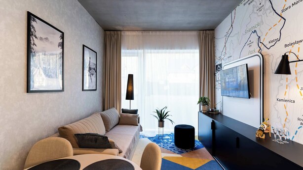 Uma sala de estar moderna com um sofá, uma mesa de jantar e uma TV fixada na parede.