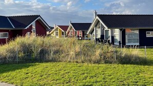 A row of houses with sloped roofs, likely in a coastal or rural area. - Grobenbrode Baltic Horizon Haven (Grossenbrode)