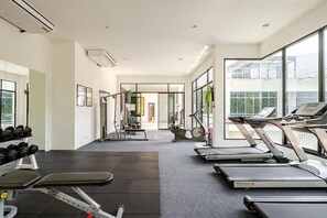 A modern gym with treadmills, dumbbells, and exercise equipment. - Exquisite Sea View Luxury Apartment by the Veloche Group (Tambon Karon)