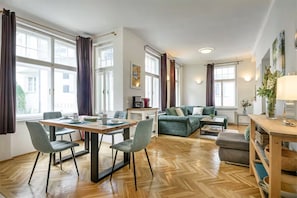 Ein großzügiger Wohnbereich mit Esstisch, Sitzgelegenheiten und einer Couch.