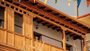 A building with a wooden balcony and stone walls.