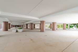 A spacious indoor area with multiple columns and planters. - Premium Living with Pool & Garage by HostWise (Vila Nova de Gaia)