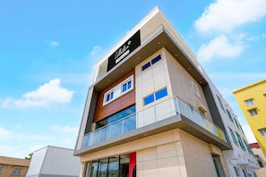A multi-story building with a prominent sign at the top.