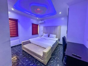 Ein Schlafzimmer mit Bett, Nachttisch und Stuhl.