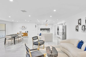 A modern interior with a dining area, kitchen, and living space. - Hollywood Hills Oasis Pool 7BR Retreat (Hollywood)