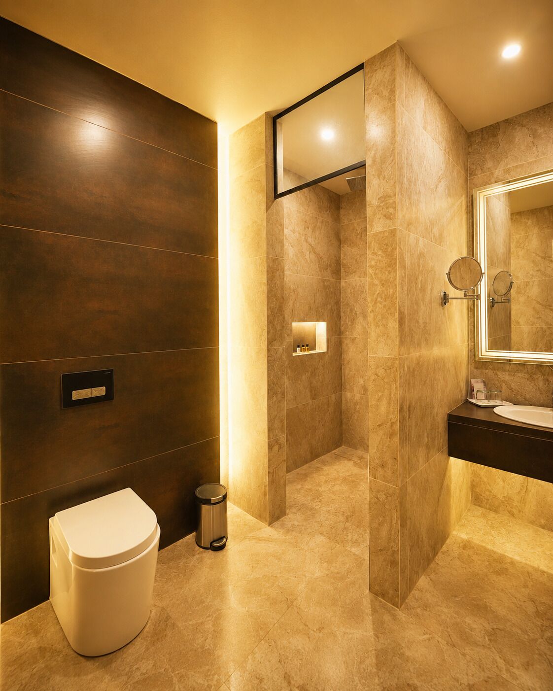 A modern bathroom with a toilet, bidet, and a mirror.