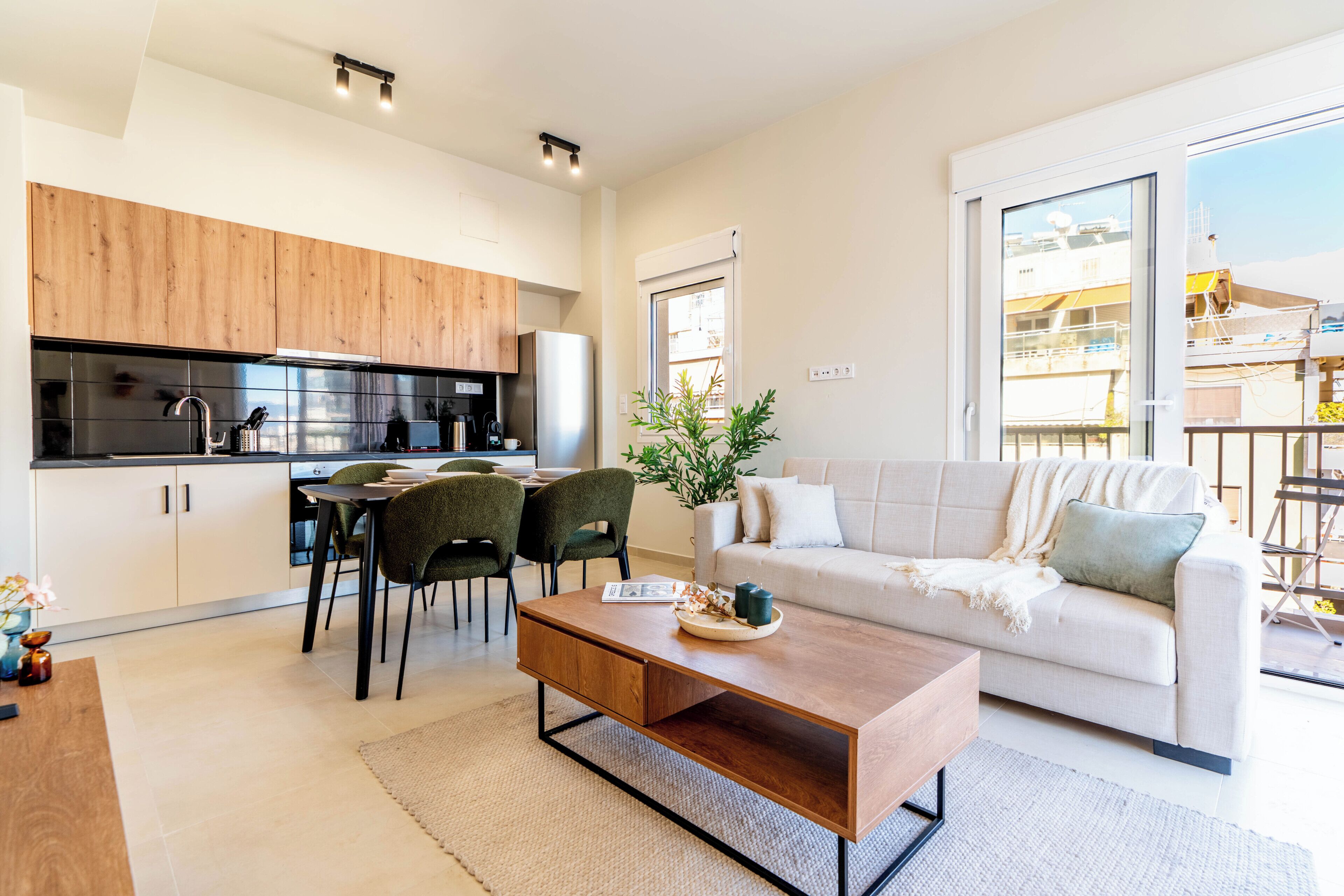A modern apartment with a kitchen, dining area, and living room.