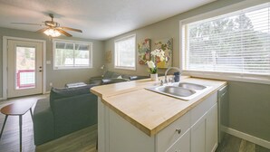 A kitchen with a wooden countertop, a double sink, and a ceiling fan. - Walk to Ski Lifts! Apt in Heart of Red River (Red River)