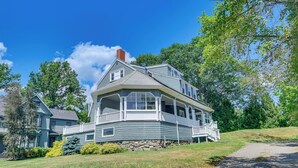 A two-story house with a wrap-around porch and a stone foundation. - Walk to Beach & Oceanside Trails! Family Retreat (York Harbor)