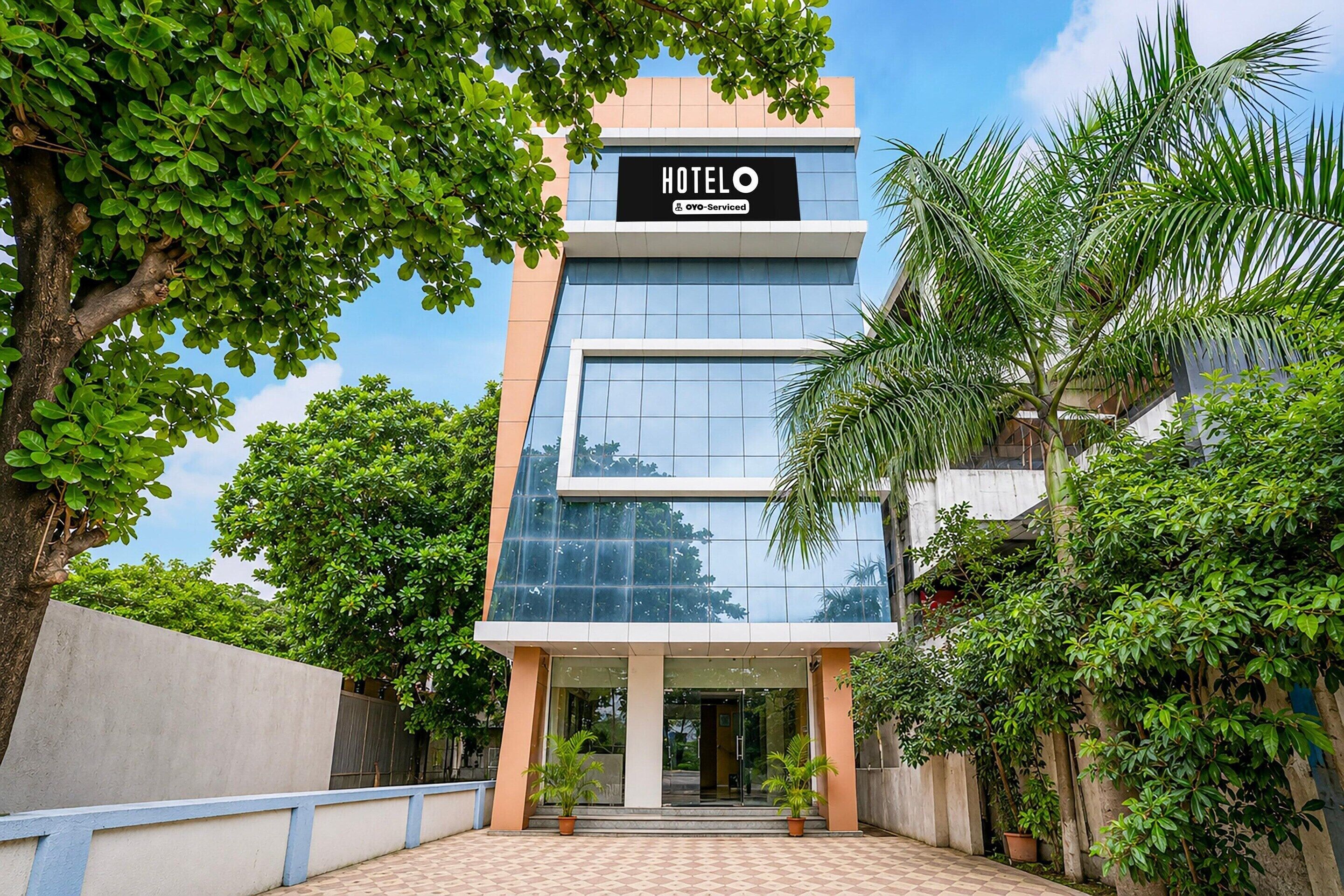 A modern hotel building with a sign that reads 'HOTEL' and 'YO-Serviced'.