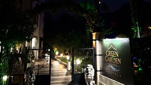 A hotel entrance with a sign reading 'GREEN GARDEN HOTEL' and a lion statue. - Green Garden Göynük Hotel  (Kemer)