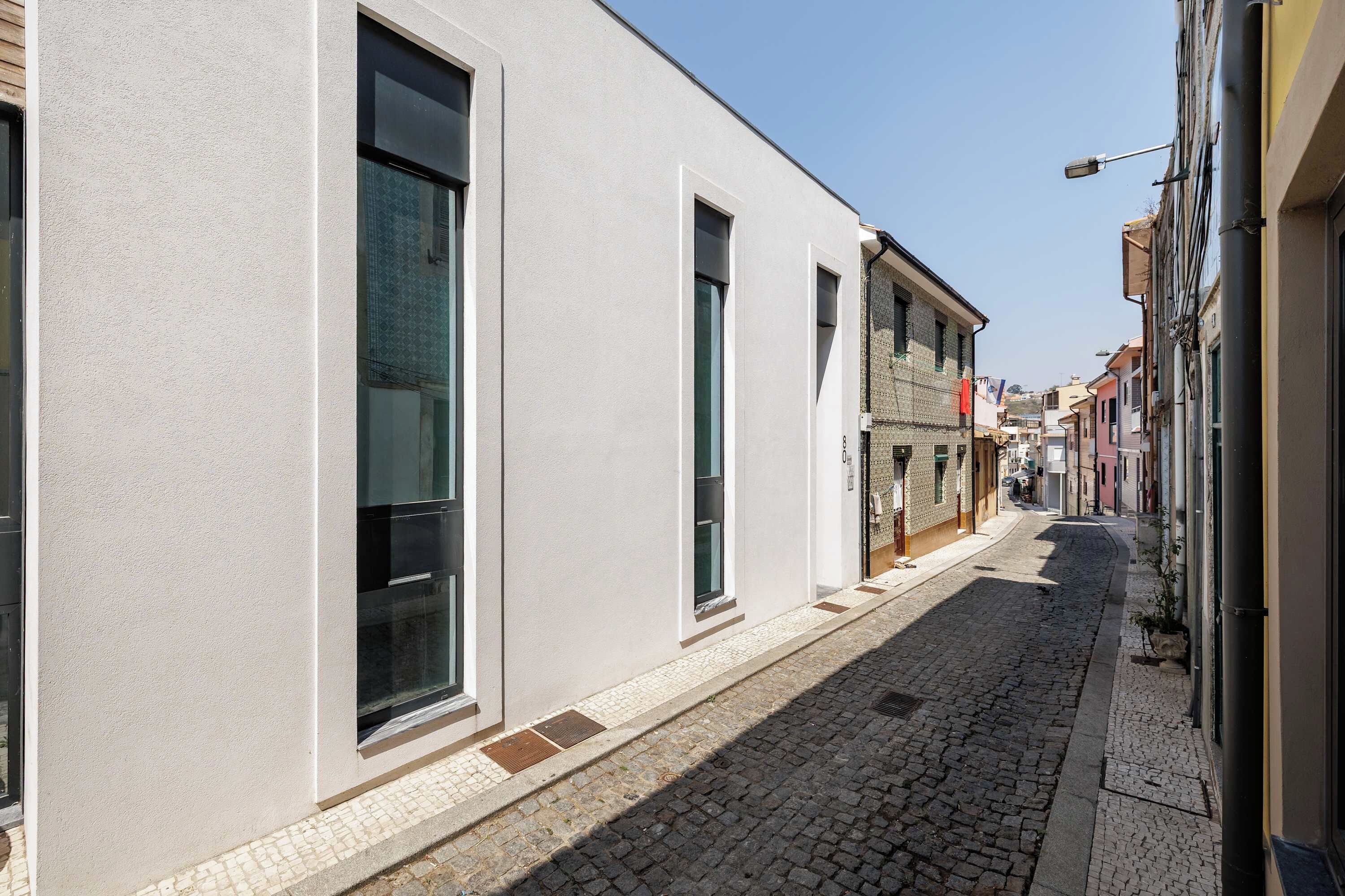 A narrow cobblestone street with buildings on either side.