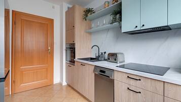 Family Apartment, Balcony | Private kitchen | Coffee/tea maker, microwave, electric kettle, toaster