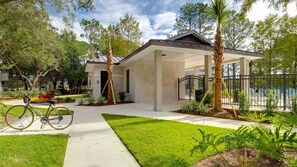 A residential property with a covered patio, a swimming pool, and a bicycle parked outside. - 🦩Book Me Baby! See You at the Bayou in Miramar Beach🦩 (Miramar Beach)