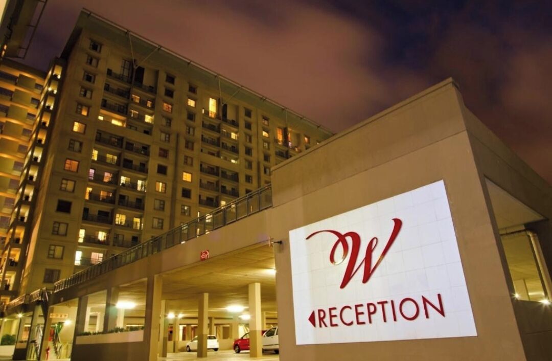 A building with a sign labeled 'RECEPTION' on the facade.