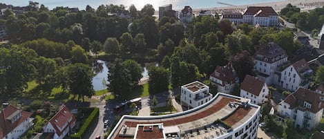 A coastal town with a mix of traditional and modern architecture, a river, and a beach.