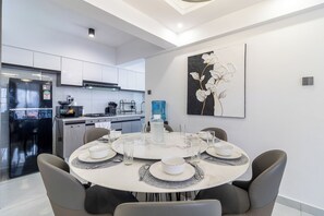 A modern kitchen with a built-in refrigerator, stove, and microwave. - The Westlands Haven, 2BR,  2 King Beds, Walk to Sarit & GTC,  Gym + Balcony (Nairobi)