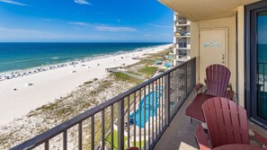 A balcony with a view of a beach and a pool. - Phoenix Iv 4082 1 Bedroom Condo (Orange Beach)