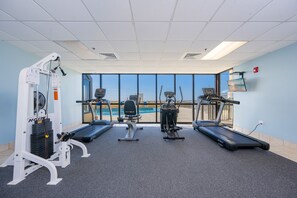 A gym with treadmills, a stationary bike, and a weight machine. - Phoenix Iv 4082 1 Bedroom Condo (Orange Beach)