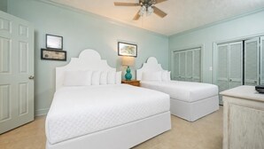 A bedroom with two beds, a ceiling fan, and a dresser. - Phoenix Ix 1202 2 Bedroom Condo (Orange Beach)