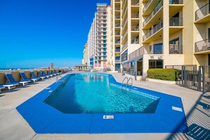 A swimming pool with blue tiles, a lifeguard chair, and a flag indicating no diving. - Phoenix Iv 4062 1 Bedroom Condo (Orange Beach)