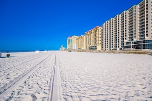 A snow-covered beach with a row of high-rise buildings. - Phoenix Iv 4022 1 Bedroom Condo (Orange Beach)