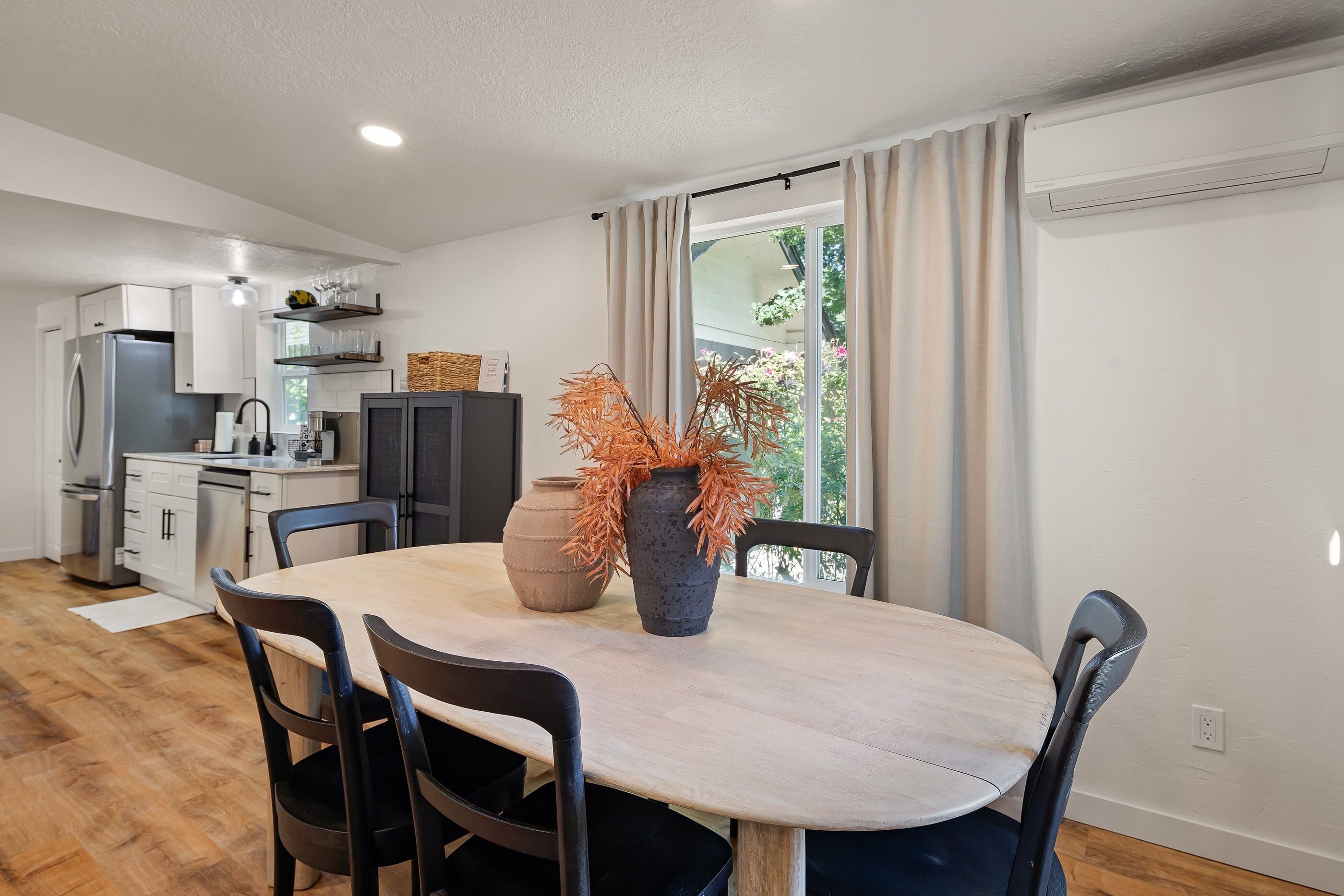 A modern kitchen with white cabinets, a built-in oven, and a refrigerator.