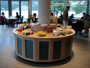 A buffet setup with various dishes and a central serving area.