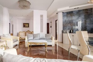 A spacious living room with a marble floor, a chandelier, a sofa set, and a dining area with a view. - Perfect 4-bedroom apartment with AC in serene T'bilisi (T'bilisi)