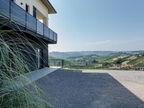 Ein modernes Gebäude mit einem Balkon mit Blick auf eine ländliche Landschaft.