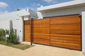 A modern house with a large wooden garage door and a small garden.