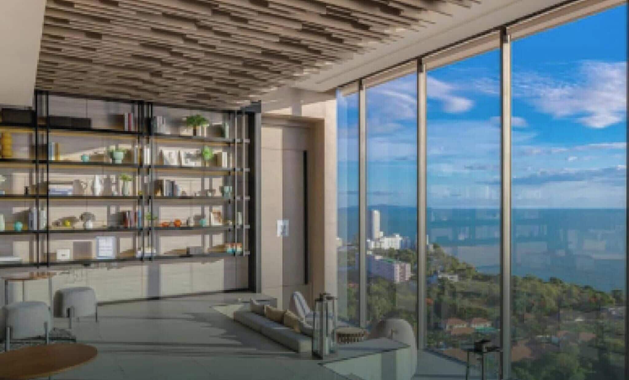 Une chambre moderne dotée d’une grande fenêtre, d’une bibliothèque intégrée, d’un coin salon et offrant une vue sur le paysage urbain.