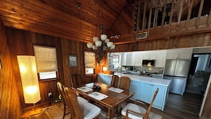 A wooden interior with a dining area, kitchen, and a staircase. - Beautiful, private Florida home surrounded with tropical forest in Jupiter farms (Jupiter)