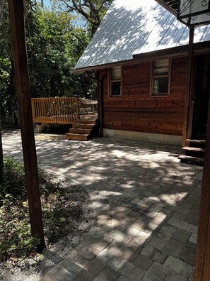 A wooden cabin with a porch, a wooden deck, and a metal roof. - Beautiful, private Florida home surrounded with tropical forest in Jupiter farms (Jupiter)