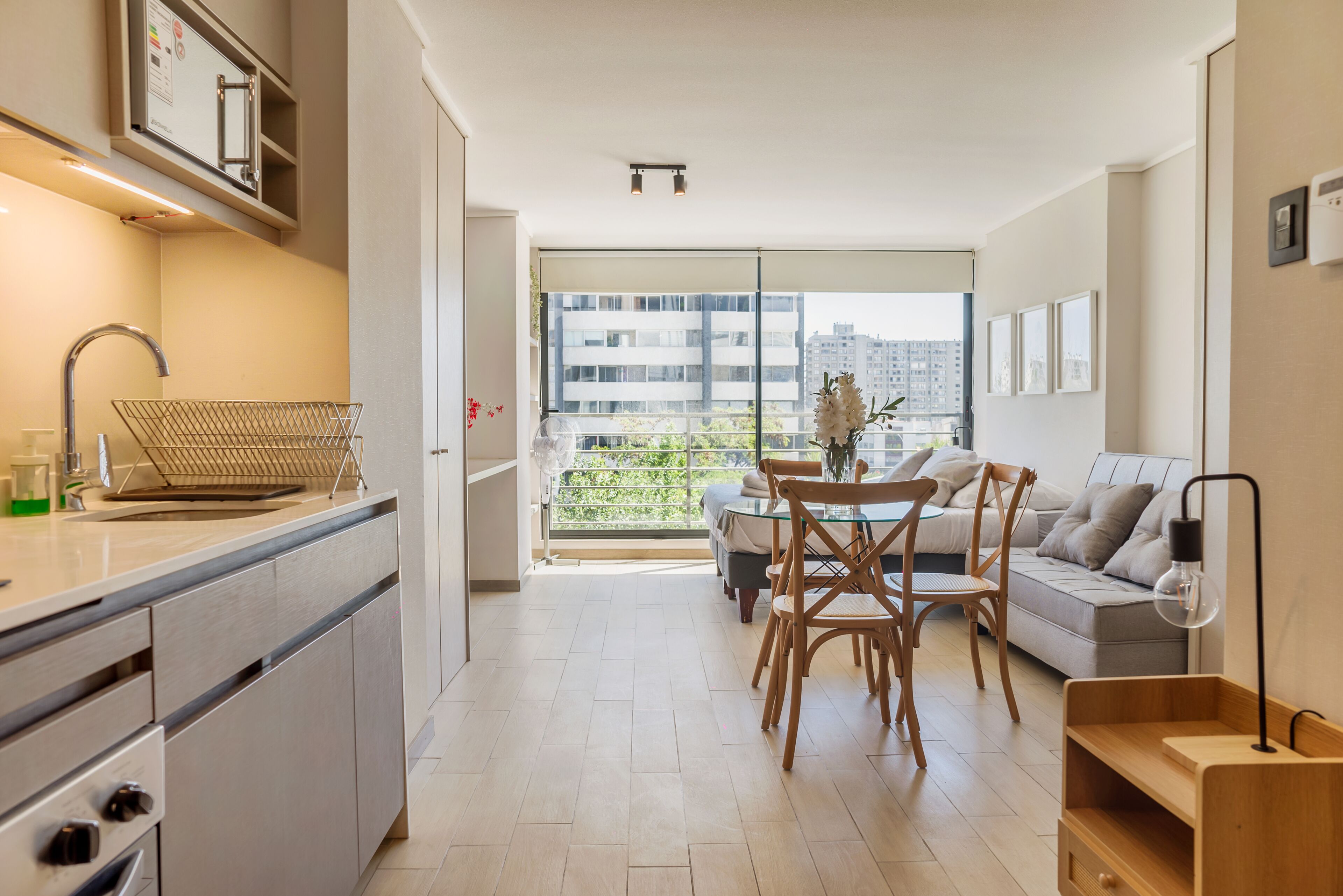 A modern apartment with a kitchen, dining area, and living space.
